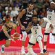 United States’ Donovan Mitchell, center and France’s Evan Fournier at left races for the ball during a quarterfinal match for the FIBA Basketball World Cup in Dongguan in southern China’s Guangdong province on Wednesday, Sept. 11, 2019. France defeated United States 89-79.